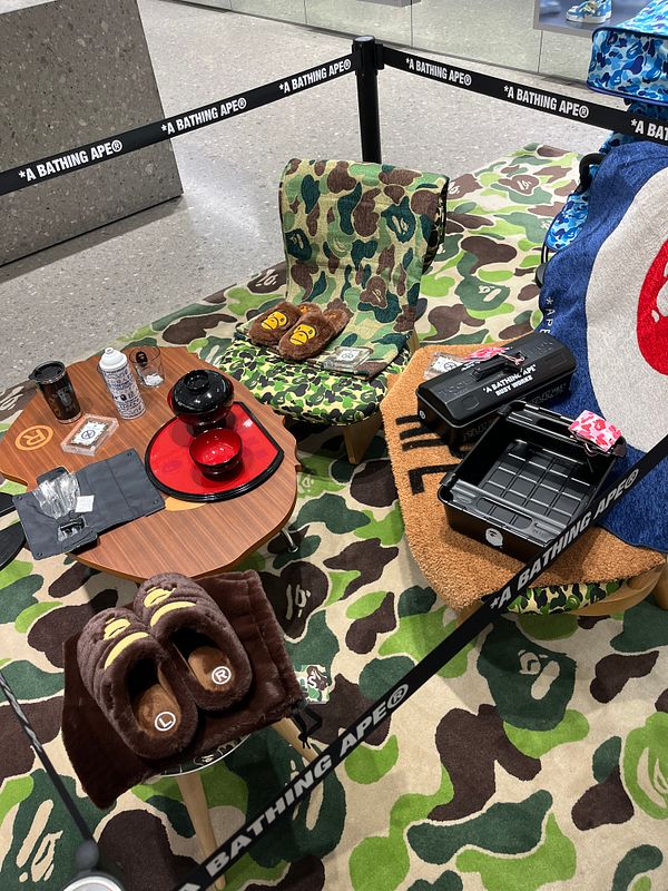 A stylish display featuring BAPE merchandise in a cozy setting.