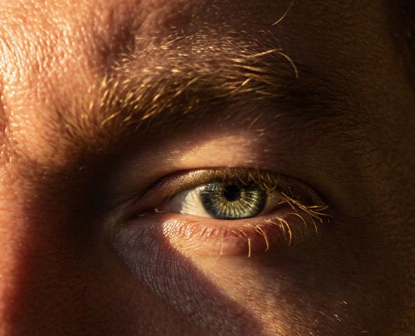 A close-up of a person's eye, showcasing intricate details and textures.