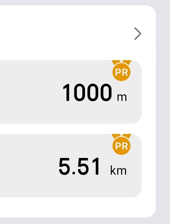 A handwritten note listing dates and running distances with workout details on a notebook.