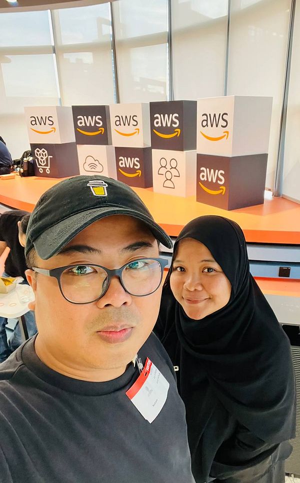 A couple poses for a selfie at an AWS office event.