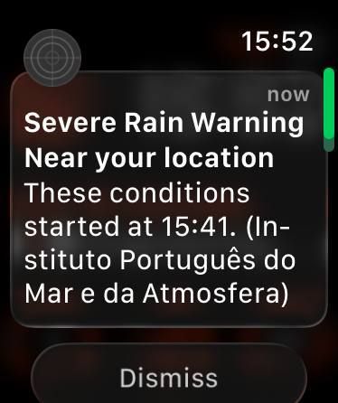 A weather alert notification for severe rain is displayed on a smartwatch interface.