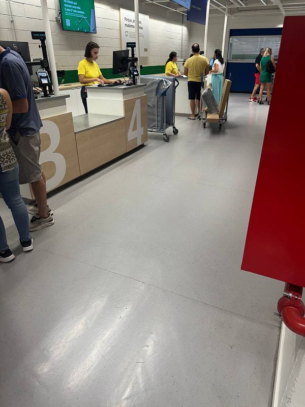 A busy IKEA return counter scene with customers and staff interacting amidst a queue dispute.