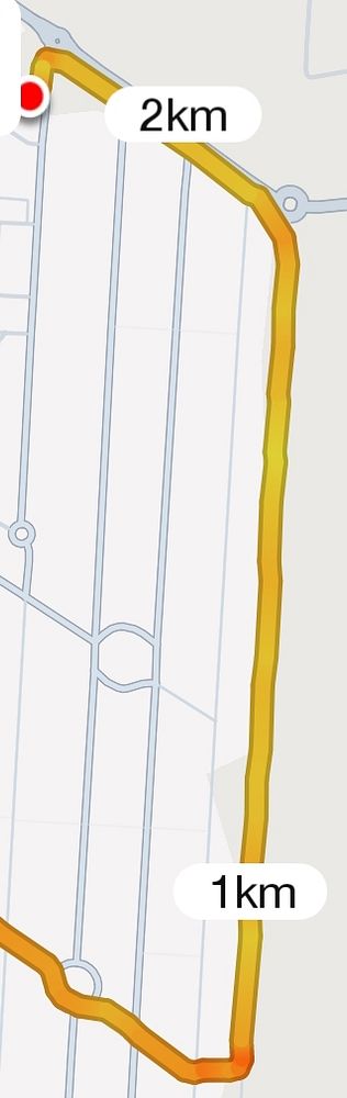 The image displays a map route for a short run, highlighting a distance of 2 km.