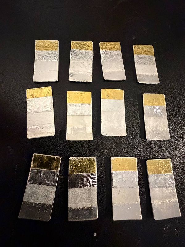 Close-up image of multiple chemical test strips on a tray with a blue background.