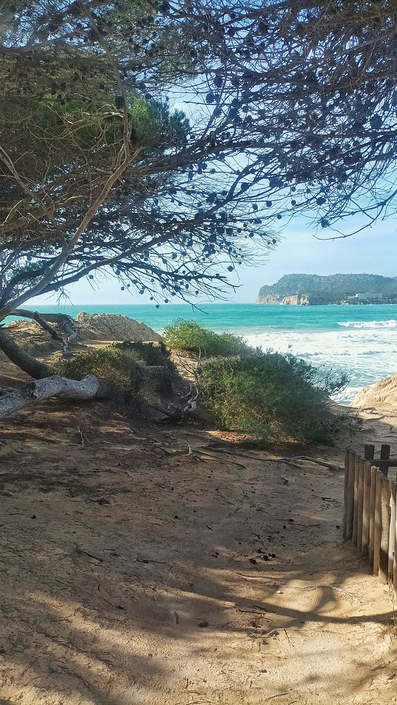 A monochrome photograph captures a person walking through a stormy urban street with heavy rain and puddles.