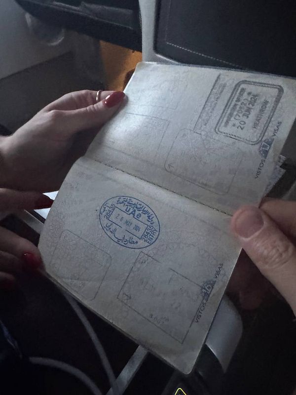 A partially open passport displaying faded stamps and personal details.