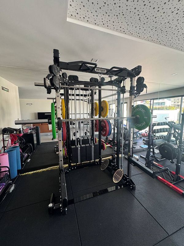 A well-equipped home gym featuring a multi-functional weight rack.