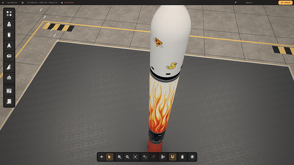 A vertically positioned rocket on a launch pad with custom flame graphics and stickers.