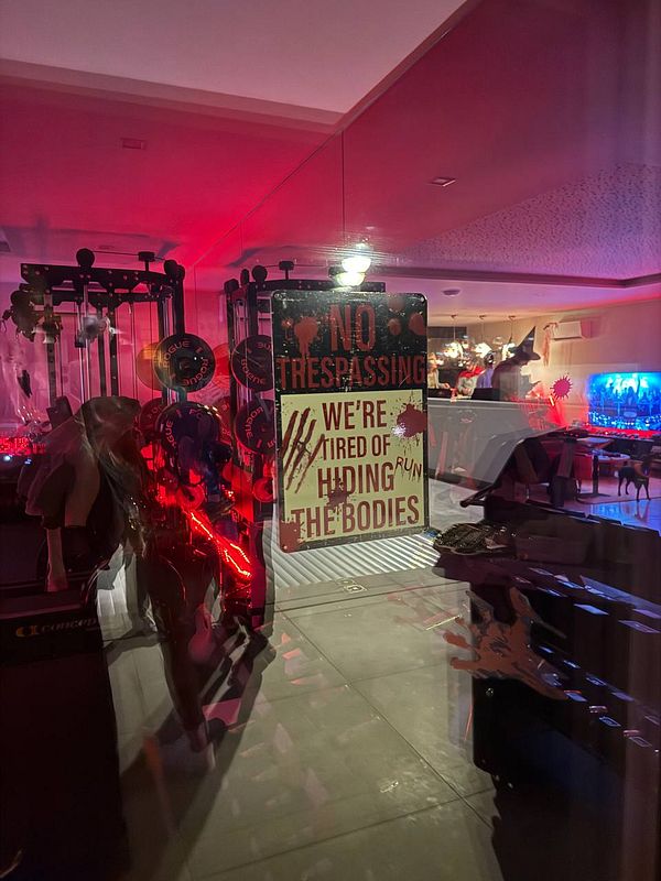 A spooky Halloween-themed interior featuring a humorous warning sign.