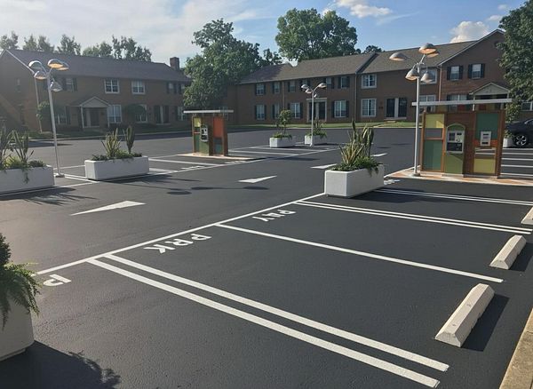 A well-maintained parking lot featuring designated parking spaces and decorative planters.