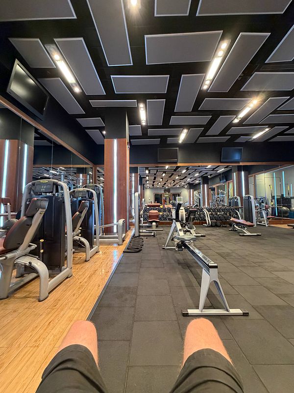 Photo of a modern gym interior with exercise equipment and a spacious, bright workout area.