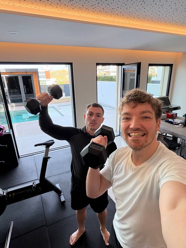 A person walking away on a city sidewalk near a crosswalk during daytime.