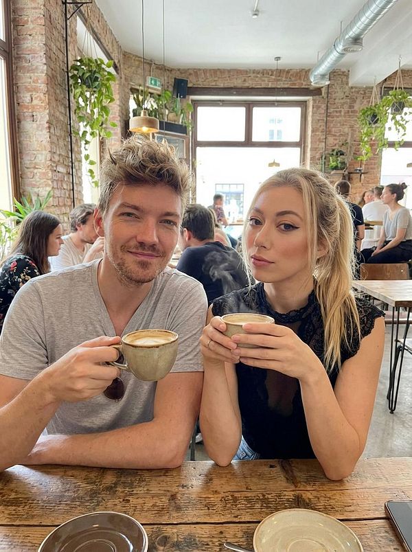 A couple enjoys coffee together in a cozy café setting.