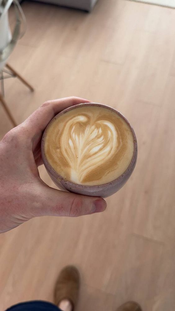 Portrait of a young person with long dark hair against a dark background.