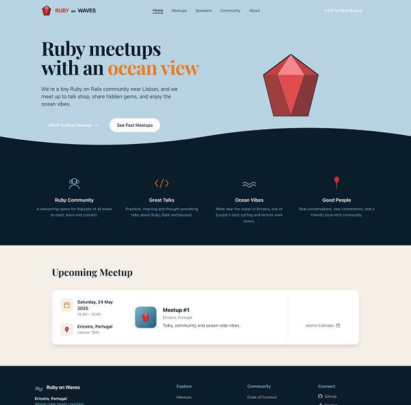 A man wearing glasses is speaking into a microphone and gesturing with his hand against a dark, possibly stage background.