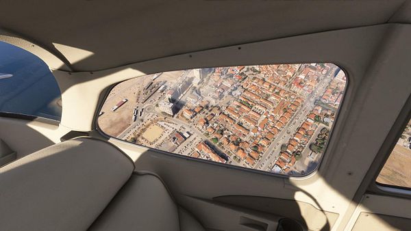 Aerial view of Costa de Caparica from inside an aircraft.
