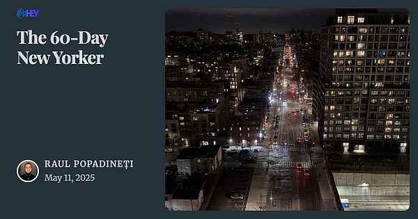 A nighttime cityscape view of a street in New York City, featuring illuminated buildings and traffic.