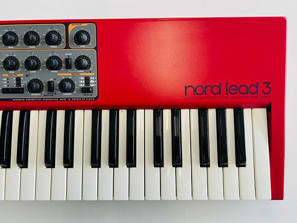 A close-up view of a Nord Lead 3 synthesizer showcasing its controls and keys.