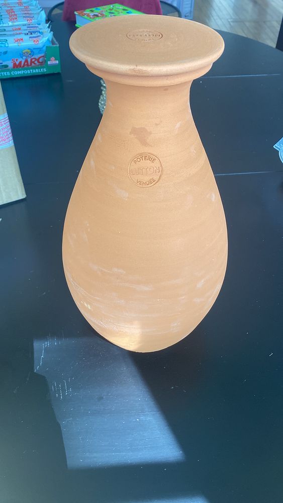 Portrait of a man wearing glasses and a green jacket.