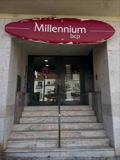 The image depicts the entrance of a Millennium bcp bank branch.