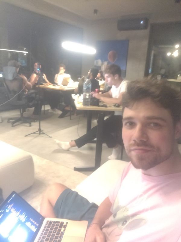 A group of people is working together in a modern co-working space.