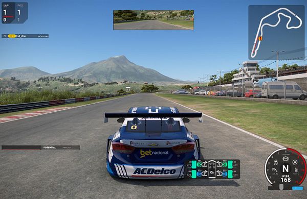 Screenshot of Automobilista 2 running on macOS with a controller showing smooth gameplay, alongside macOS Finder window and taskbar icons.