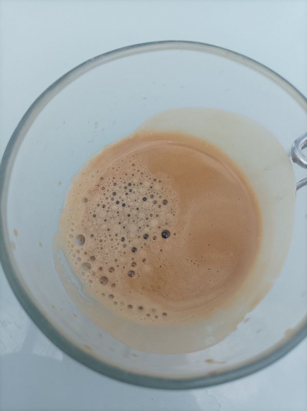 A close-up view of a glass cup filled with espresso.