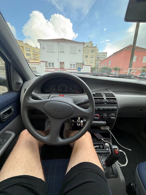 The image captures the interior of a car from the driver's perspective, focusing on the steering wheel and dashboard.
