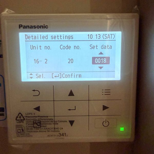 Display of a hotel AC control panel in maintenance mode with blue-lit digital temperature settings.