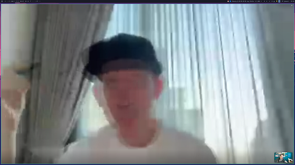 Scenic aerial view of a city with a river running through it, surrounded by lush greenery and urban buildings under a partly cloudy sky.