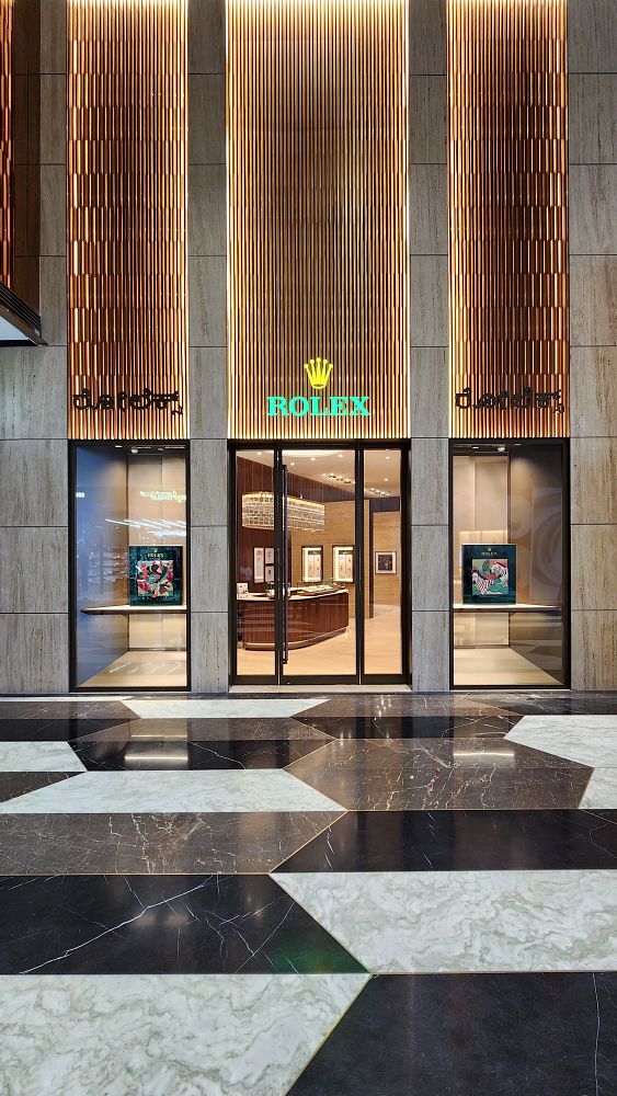The image depicts the entrance of a new Rolex boutique with a modern design.