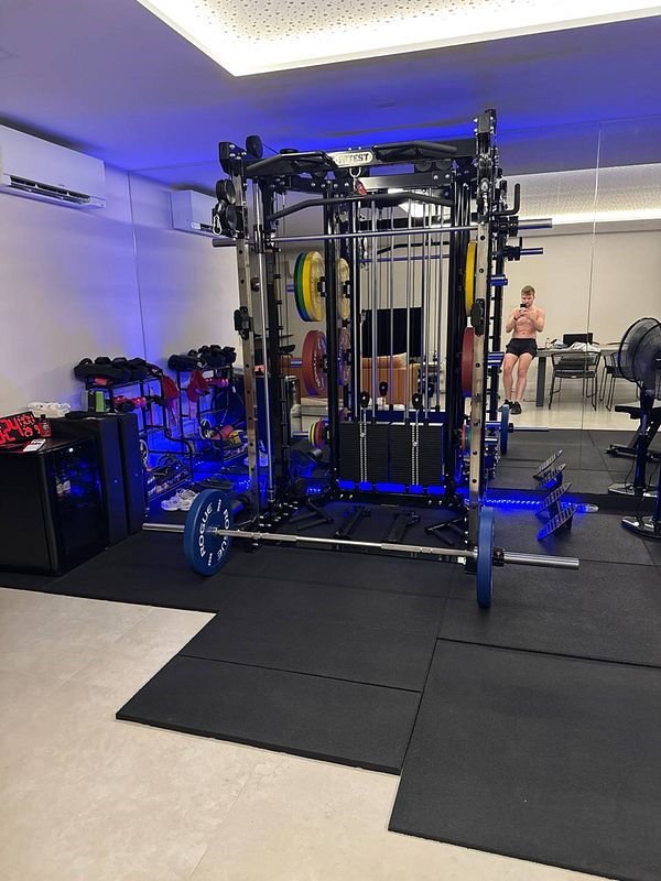 A well-equipped home gym featuring a multi-functional weight machine and various fitness equipment.