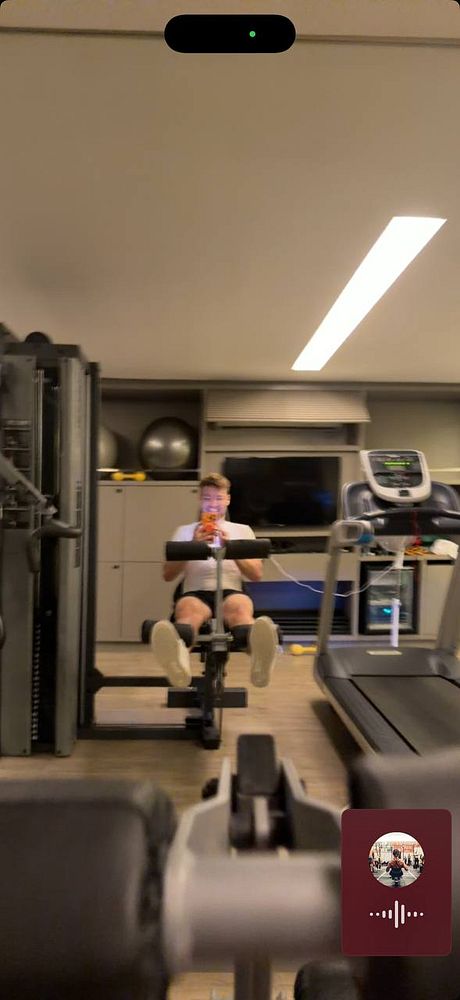 Pumpkins arranged in a rectangular wooden crate on straw next to another ceramic pumpkin and a hay bale.