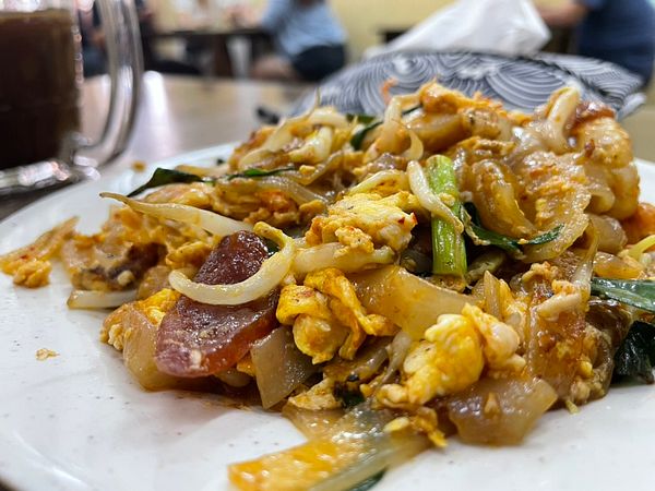 A plate of Penang char kway teow featuring a mix of ingredients.