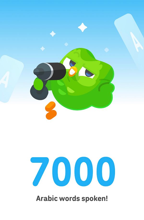 A Duolingo achievement screen displaying '7000 Arabic words spoken' with the green owl mascot holding a microphone.