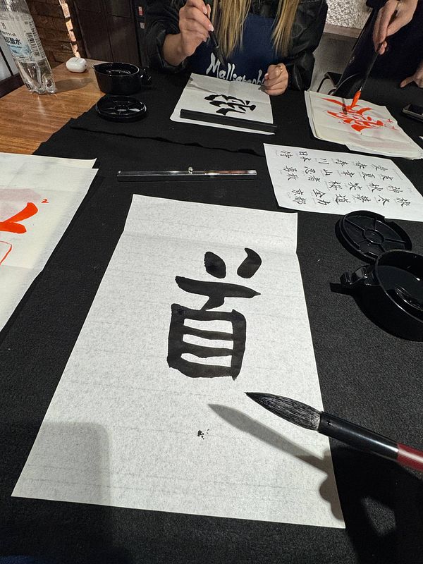 A calligraphy class in Japan featuring participants practicing traditional writing techniques.