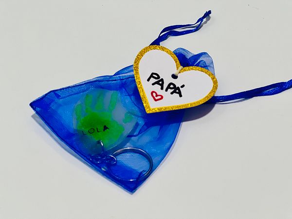 A heartfelt Father's Day gift featuring a handprint keepsake and a decorative tag.