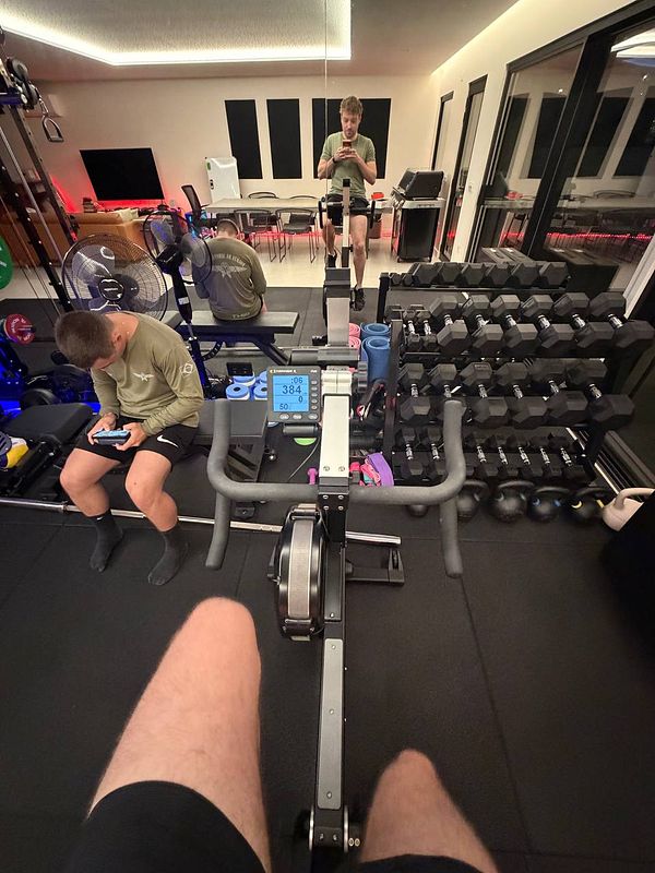 A home gym setup featuring two individuals engaged in different activities.