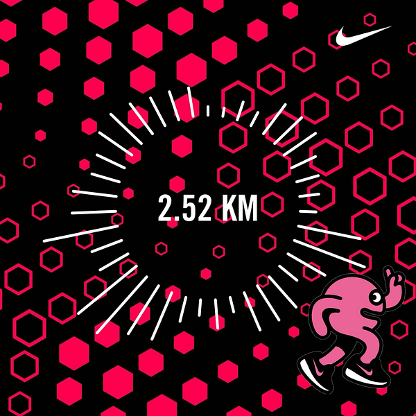 A woman jogging on a paved path along a river with a bridge and trees in the background in winter conditions.