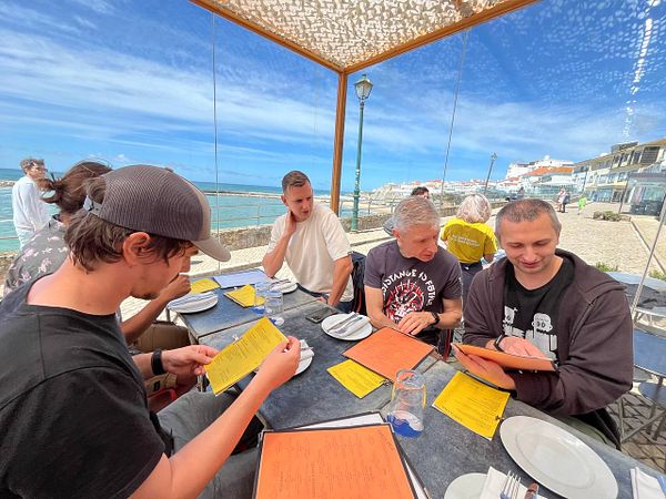 A large gathering of people at an indoor event space celebrating Ruby on Waves #1 with a group photo.
