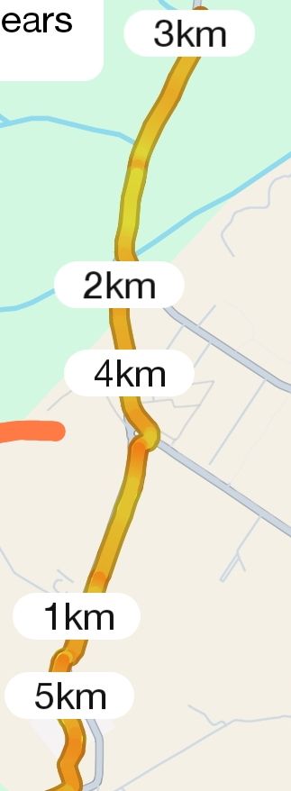 A scenic outdoor view of a tranquil lake surrounded by a dense forest under a cloudy sky.