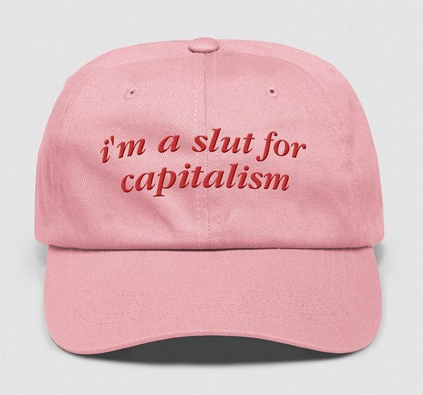 A pink baseball cap featuring bold text.