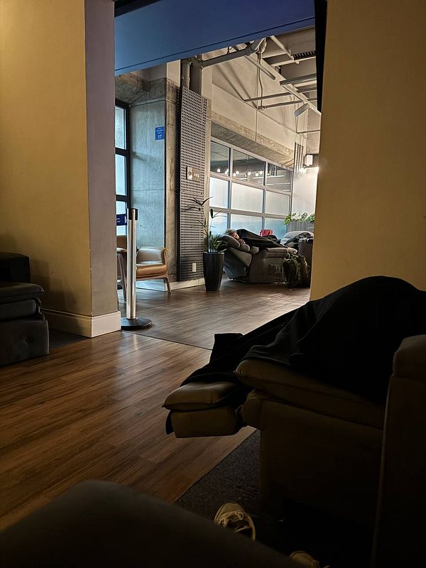 A cozy airport lounge area with seating and a view of a relaxed atmosphere.