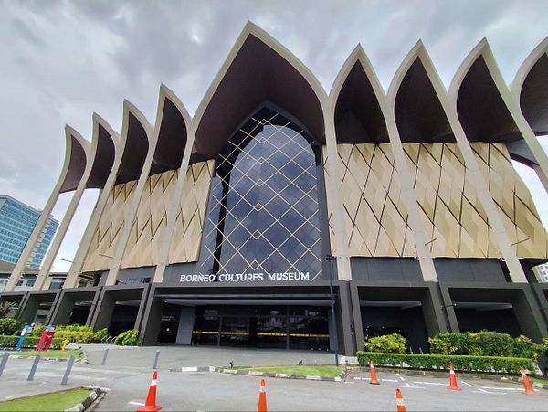 Exterior view of the Borneo Cultures Museum in Kuching with its modern architectural design and large windows.