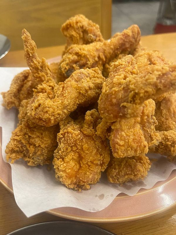 A close-up view of a pile of crispy Korean fried chicken pieces on a plate.