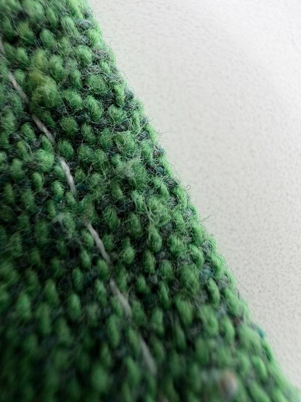 A close-up view of a textured green fabric.