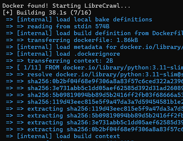 A large white industrial crane with a tall lattice boom stands against a blue sky, positioned on tracks with a counterweight arm extending backwards.