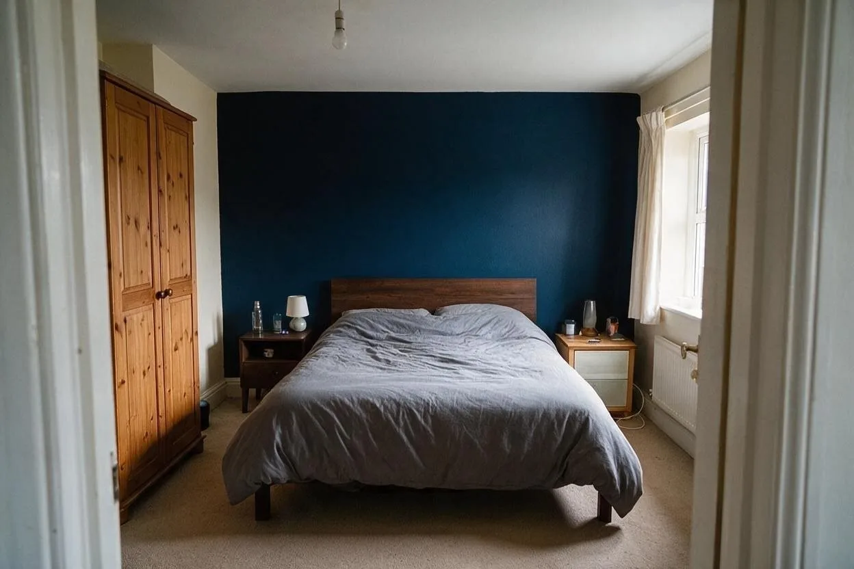 The same room after: Paint the wall behind the bed a deep inky blue.