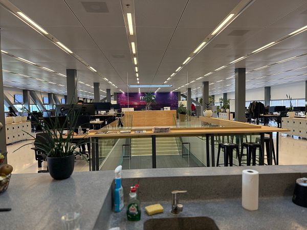 A modern office space featuring a collaborative area and workstations.