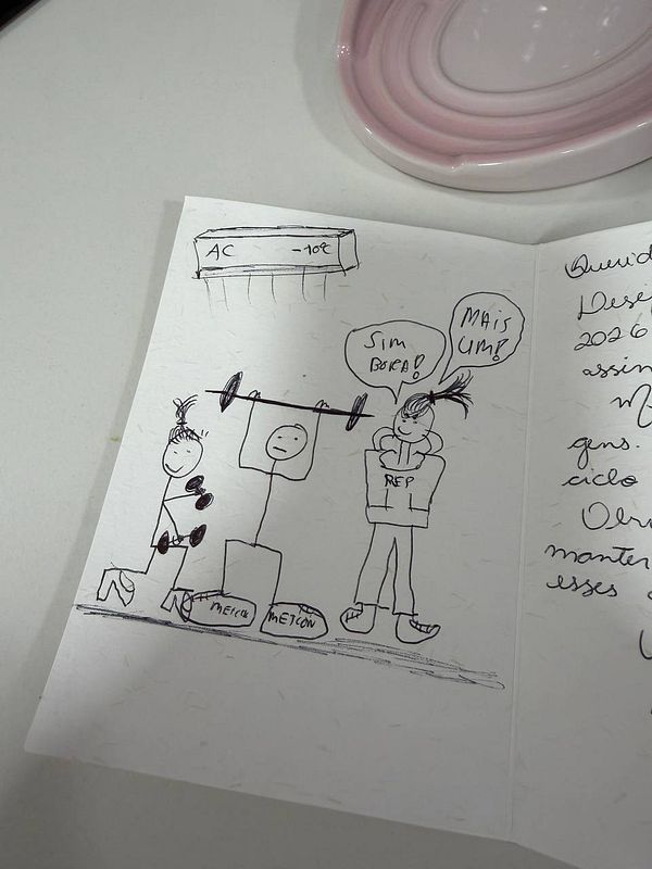 A gym locker room with benches, lockers, and a man wearing a dark shirt and camouflage shorts.